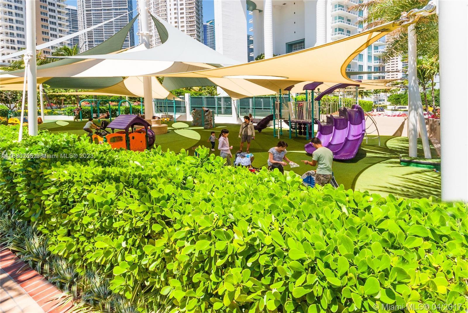 888 Brickell Key Drive, Unit 511 Miami, FL 33131 - Photo 21 of 26 a view of a patio with table and chairs under an umbrella