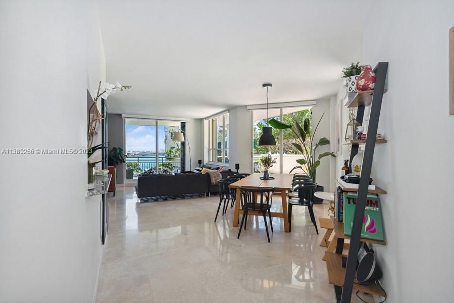888 Brickell Key Drive, Unit 511 Miami, FL 33131 - Photo 3 of 26 a dining room with furniture and a floor to ceiling window