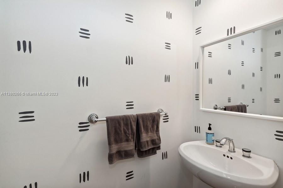 888 Brickell Key Drive, Unit 511 Miami, FL 33131 - Photo 9 of 26 a bathroom with a sink and mirror