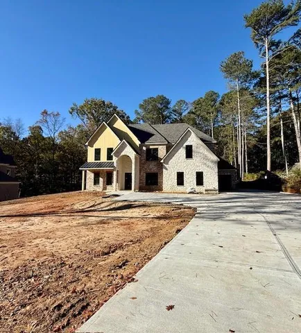 a view of white house with a big yard and palm trees