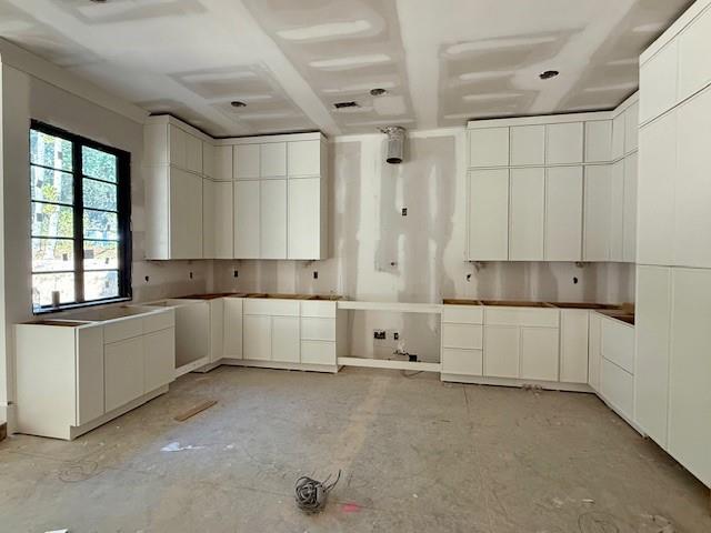 1258 Prospect Road Lawrenceville, GA 30043 - Photo 6 of 6 a large white kitchen with white cabinets and a dishwasher