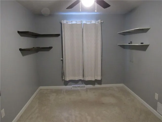 a utility room with a sink a toilet and mirror