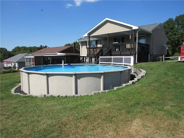 a view of house with backyard and porch