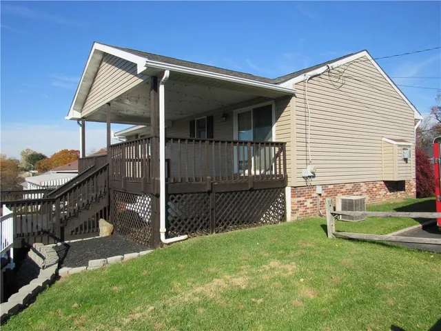 a view of house with backyard space and garden