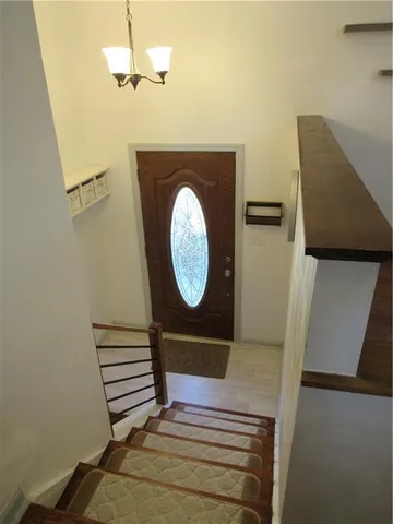 a view of a hallway with wooden floor and white walls