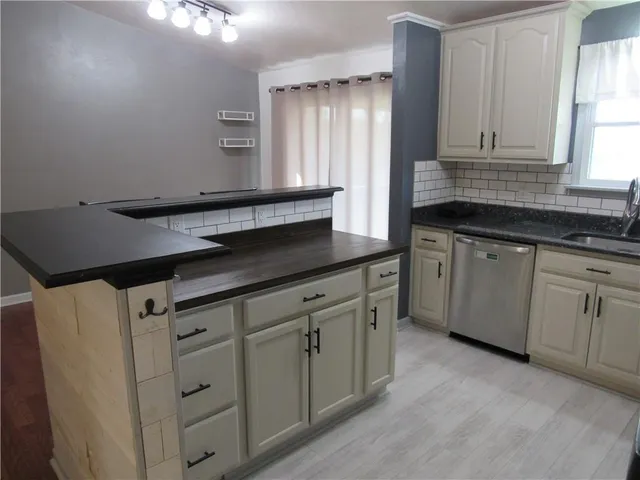 a kitchen with cabinets and window