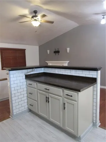 a kitchen with a counter space cabinets and appliances