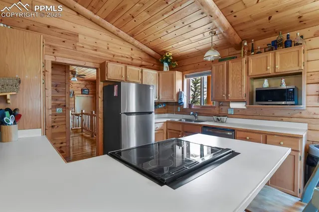 a kitchen with stainless steel appliances granite countertop a sink a refrigerator and a stove