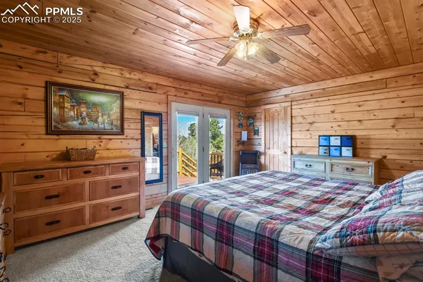 a bedroom with a bed a dresser next to a window