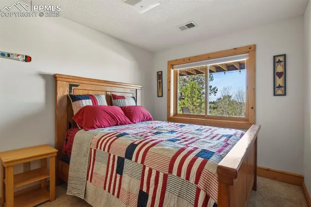 a bed sitting in a bedroom next to a window