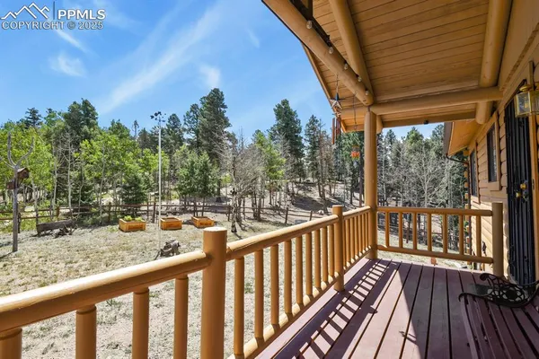 a view of balcony with wooden floor and fence