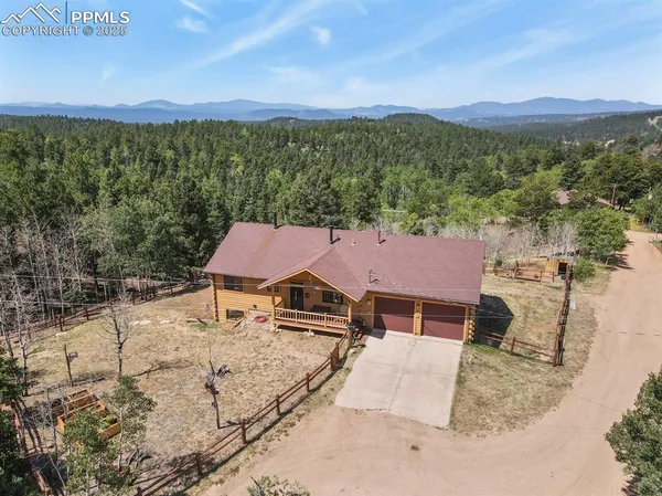 an aerial view of a house with a yard