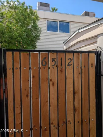 a front view of a house with a wooden fence