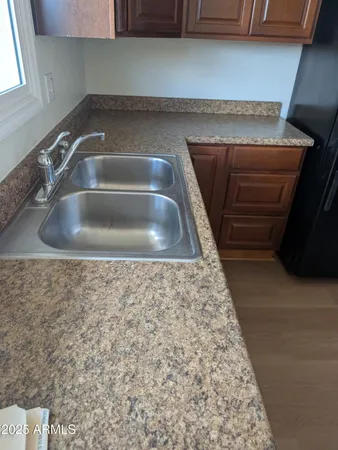 a view of a room with wooden floor and a window