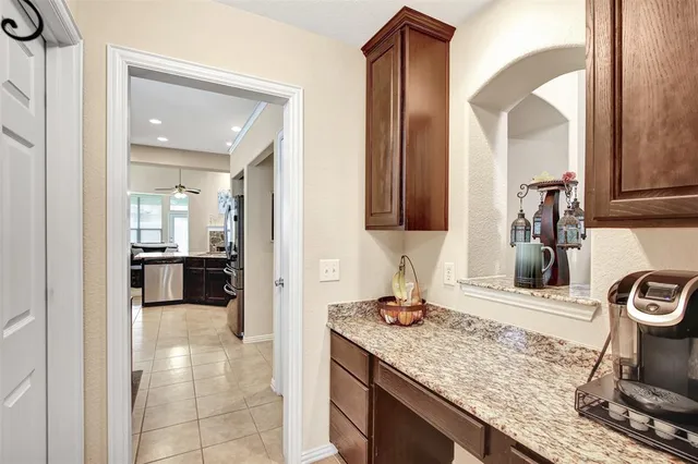 a kitchen with granite countertop kitchen island stainless steel appliances a refrigerator a stove a sink a dining table and chairs