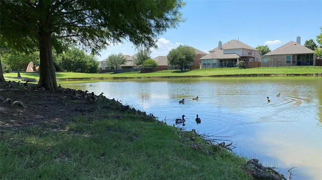 a swimming pool with outdoor seating and yard