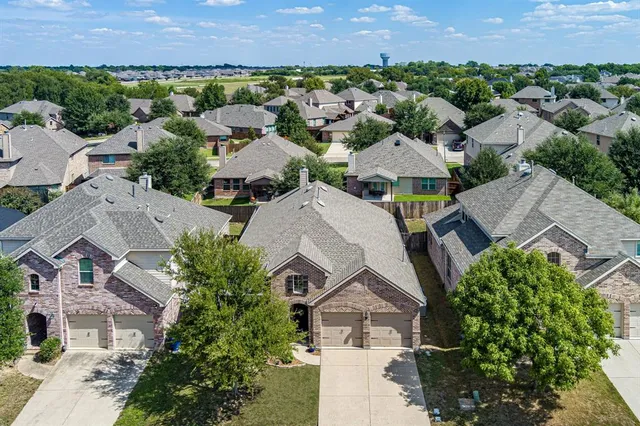 a view of a lake with a yard and large trees