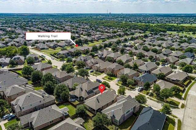 an aerial view of multiple houses with a yard