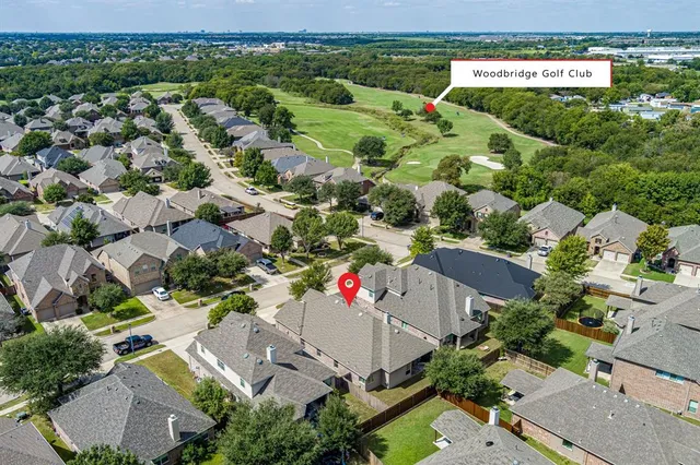 an aerial view of residential houses with outdoor space