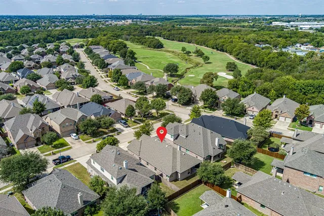 an aerial view of a houses with a yard