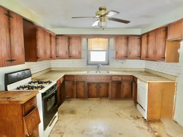 a kitchen with a stove a sink and a refrigerator