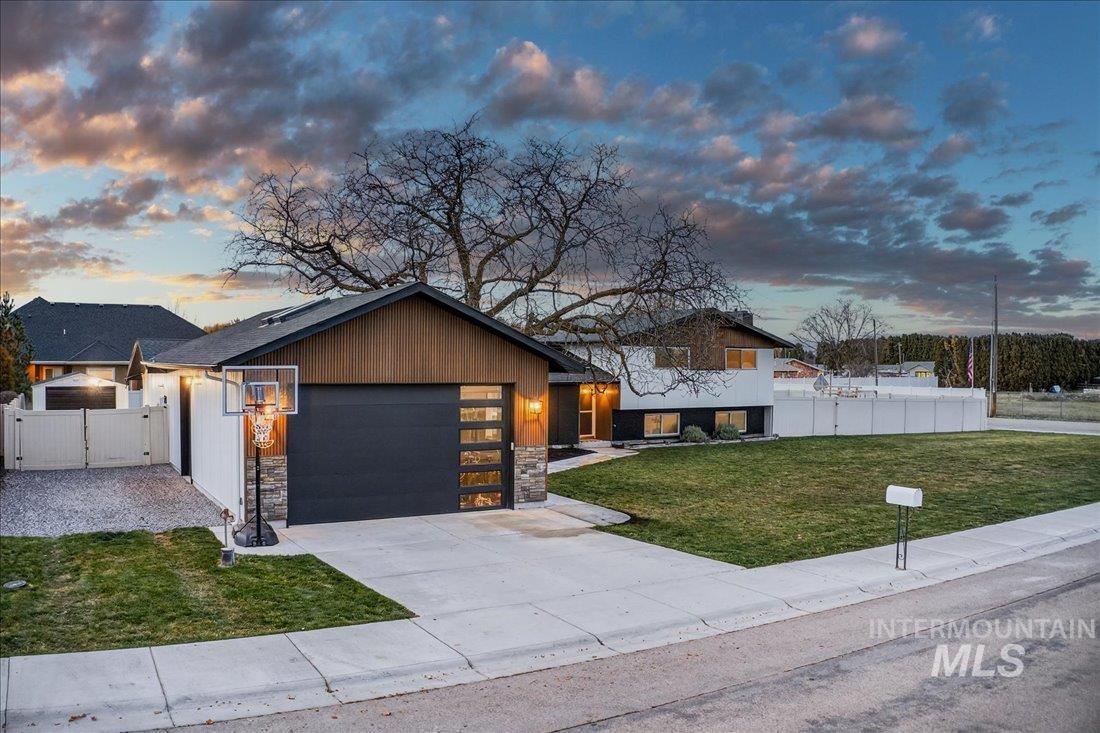 4393 North Edelweiss Street Boise, ID 83713 - Photo 2 of 42 View of front facade with concrete driveway, stone siding, and an attached garage