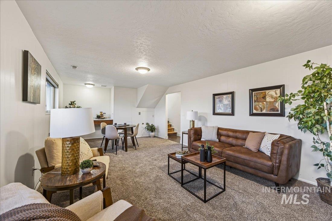 4393 North Edelweiss Street Boise, ID 83713 - Photo 27 of 42 Carpeted living area with stairs and a textured ceiling