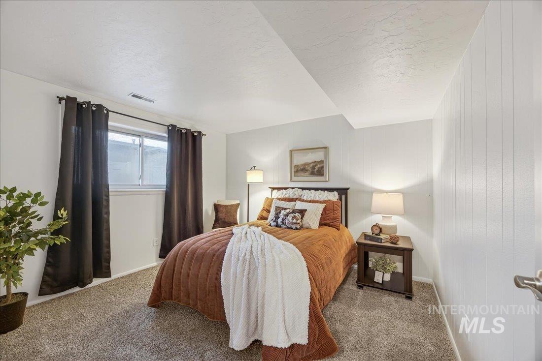 4393 North Edelweiss Street Boise, ID 83713 - Photo 28 of 42 Carpeted bedroom with baseboards and wooden walls