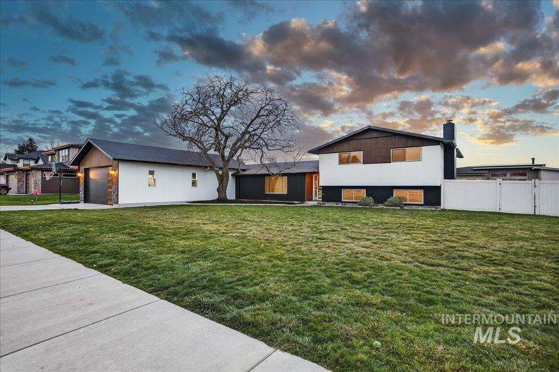 4393 North Edelweiss Street Boise, ID 83713 - Photo 3 of 42 View of front of house with a chimney, concrete driveway, a garage, and stone siding