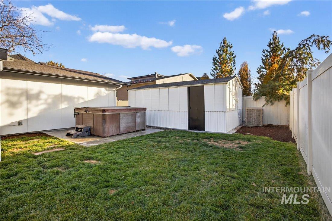 4393 North Edelweiss Street Boise, ID 83713 - Photo 40 of 42 Fenced backyard featuring a hot tub and a storage shed