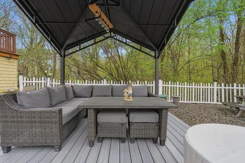 a roof deck with couch and chairs