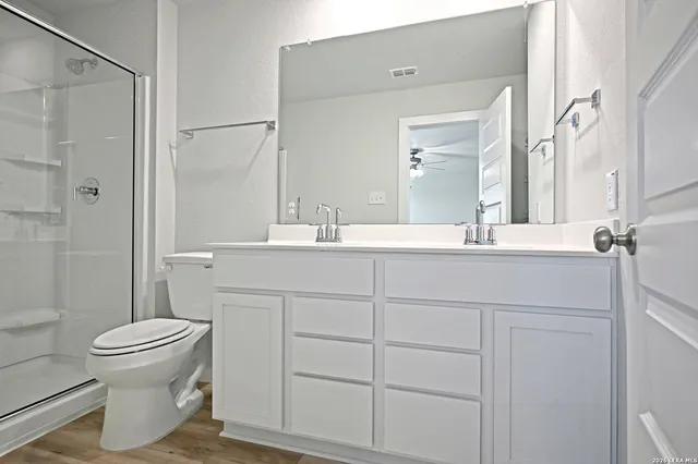 a bathroom with a sink toilet and shower