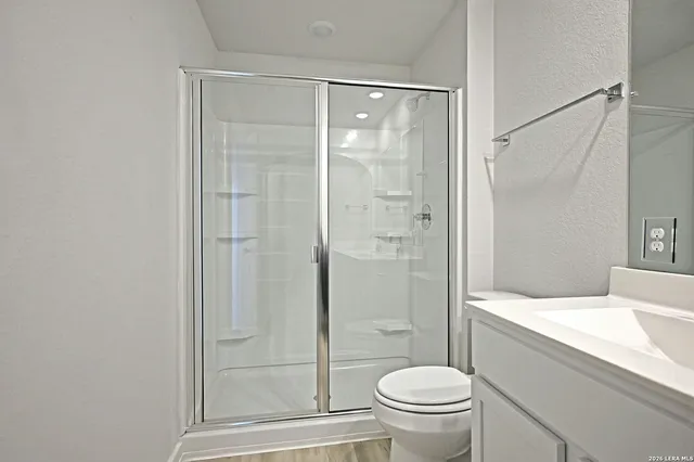 a bathroom with a shower and a toilet