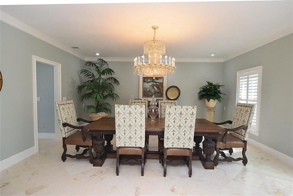 8 North Sewalls Point Road Sewall's Point, FL 34996 - Photo 12 of 33 a view of a dining room with furniture and chandelier