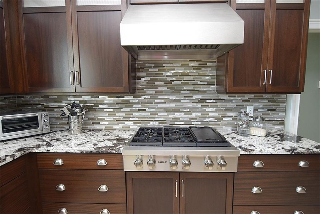 8 North Sewalls Point Road Sewall's Point, FL 34996 - Photo 29 of 33 a kitchen with granite countertop a stove and a cabinets