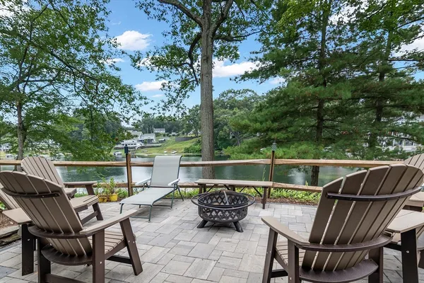 a balcony with wooden floor and outdoor seating