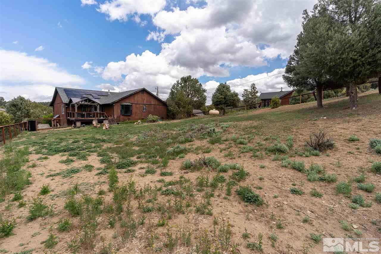 1844 Lousetown Road Reno, NV 89521 - Photo 24 of 39 a view of a large house with a big yard and large trees