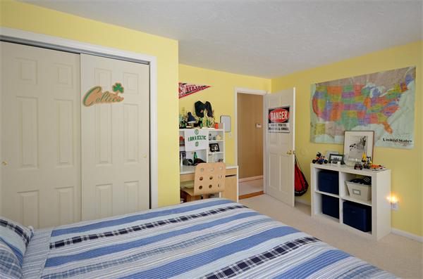 16 Nicholas Road Hopkinton, MA 01748 - Photo 16 of 28 a bedroom with a bed and a dresser in it