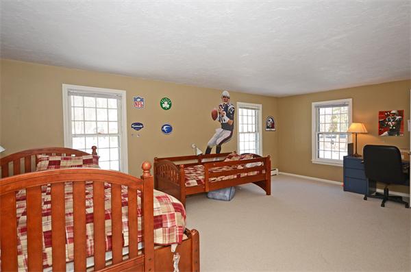 16 Nicholas Road Hopkinton, MA 01748 - Photo 20 of 28 a bedroom with two beds and a chair