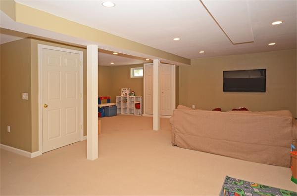 16 Nicholas Road Hopkinton, MA 01748 - Photo 23 of 28 a living room with furniture and a flat screen tv