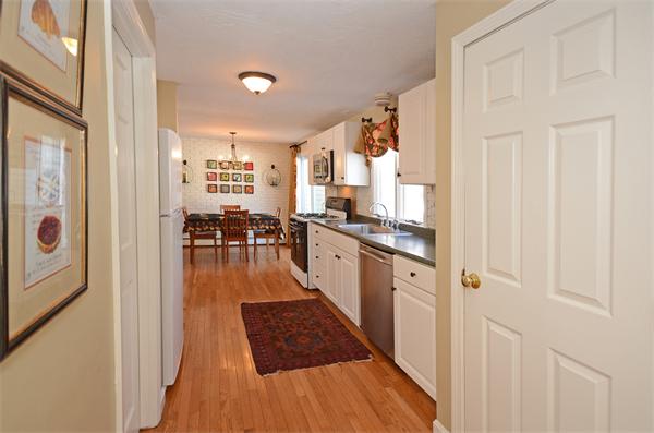 16 Nicholas Road Hopkinton, MA 01748 - Photo 9 of 28 a kitchen with granite countertop a refrigerator and wooden floor