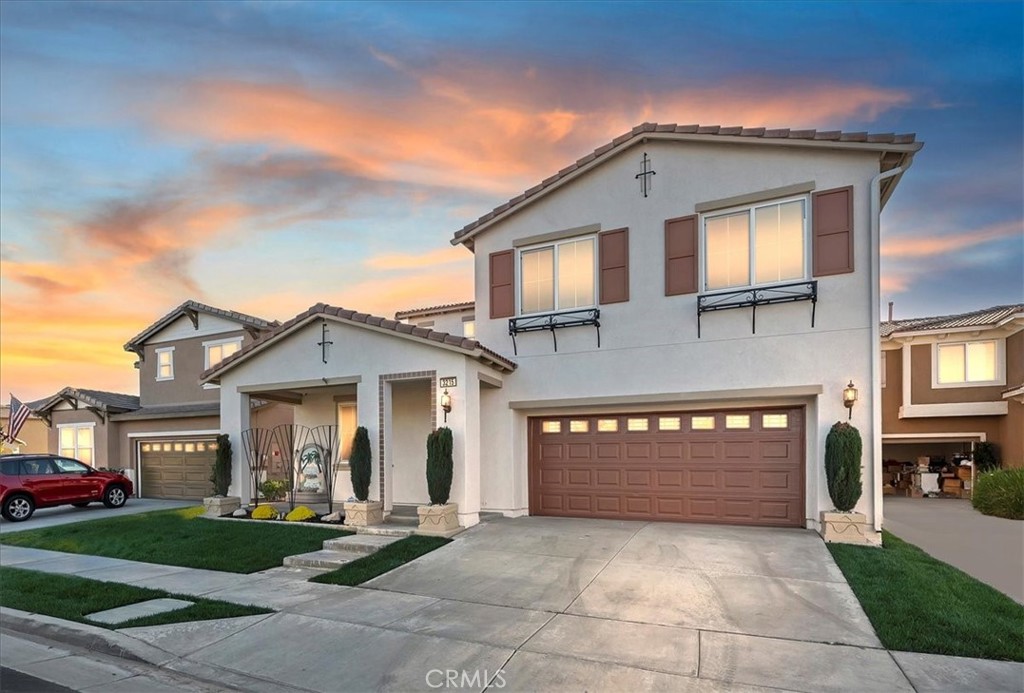 a front view of a house with a yard and garage