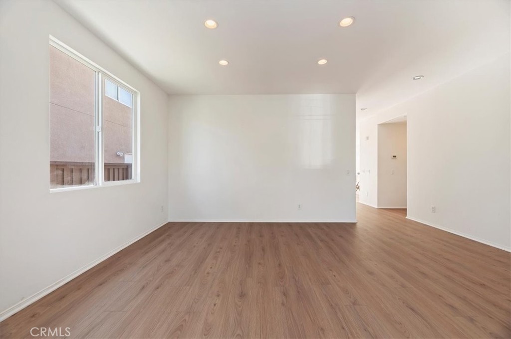 3215 Tumbleweed Road Hemet, CA 92545 - Photo 12 of 46 a view of an empty room with wooden floor and a window