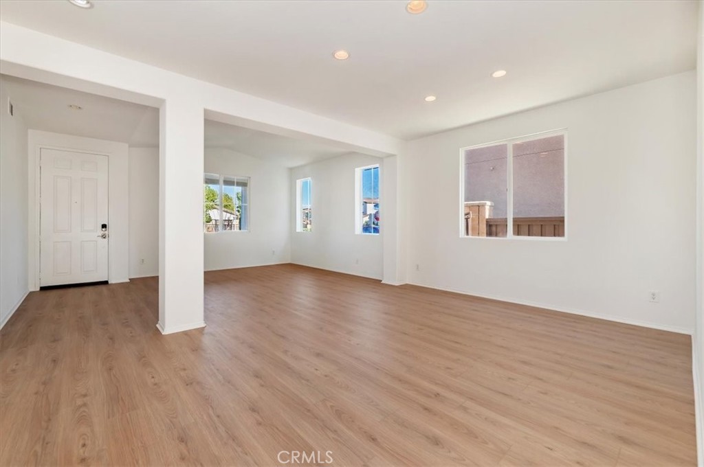 3215 Tumbleweed Road Hemet, CA 92545 - Photo 13 of 46 an empty room with wooden floor and windows
