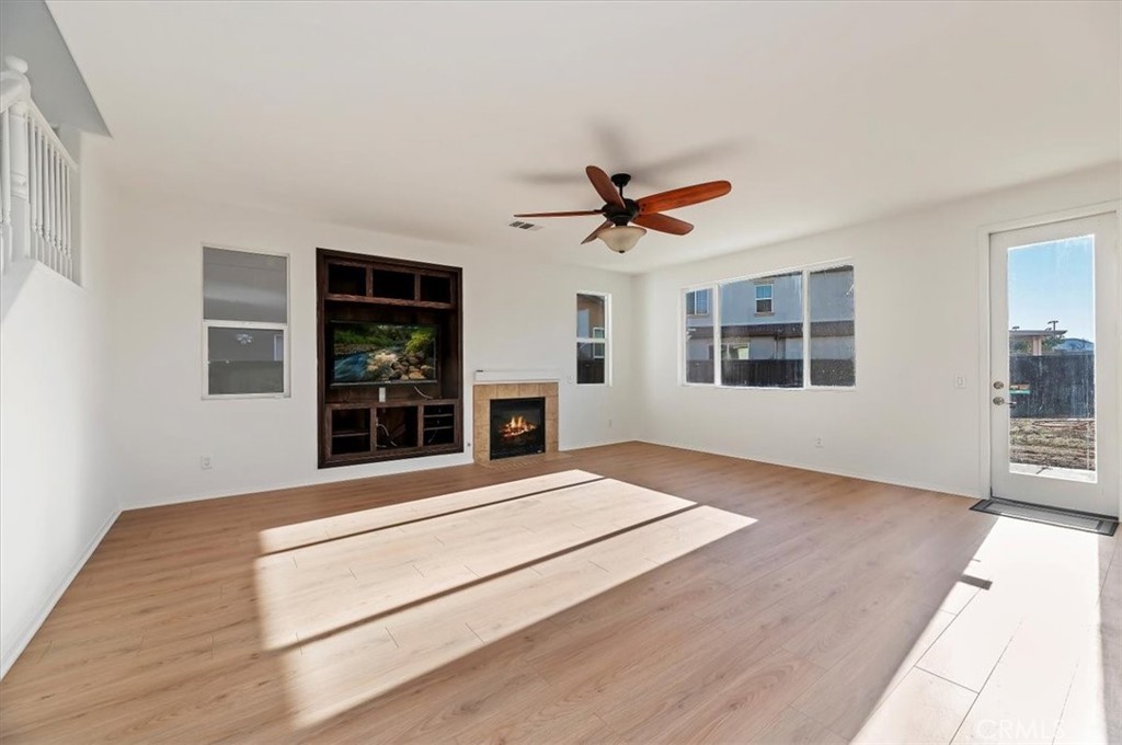 3215 Tumbleweed Road Hemet, CA 92545 - Photo 14 of 46 a view of an empty room with wooden floor and a window