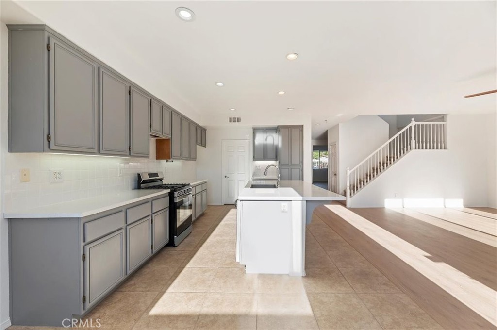 3215 Tumbleweed Road Hemet, CA 92545 - Photo 21 of 46 a kitchen with cabinets and white appliances