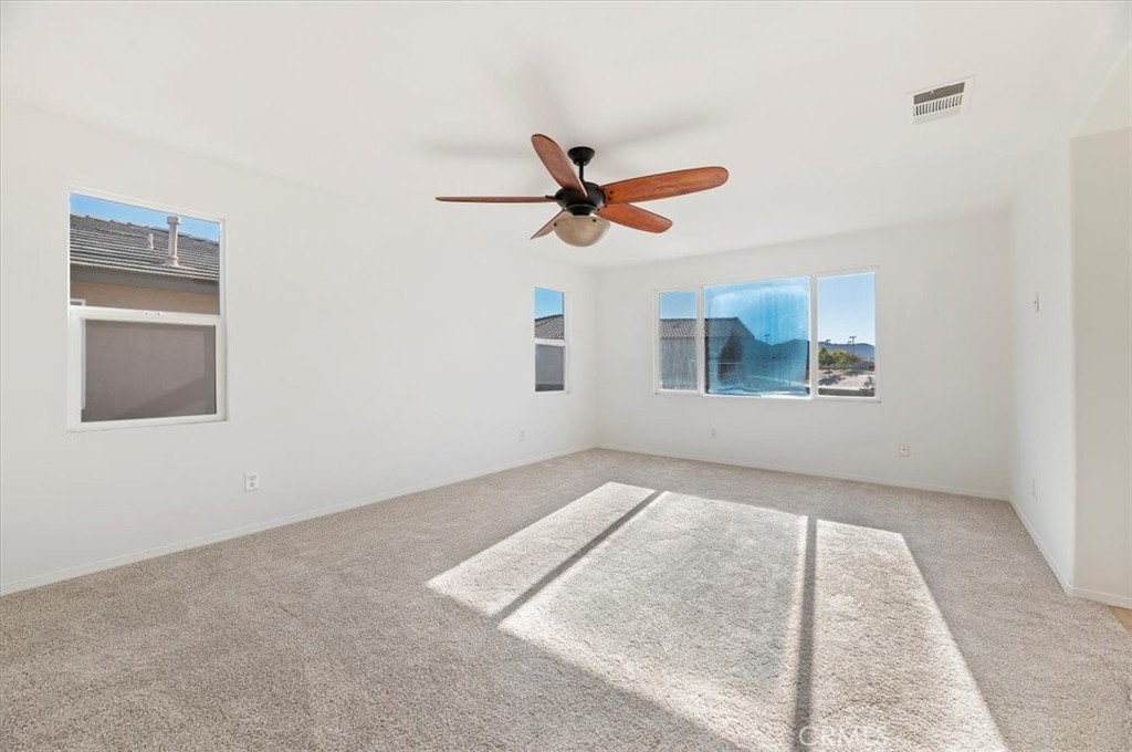 3215 Tumbleweed Road Hemet, CA 92545 - Photo 34 of 46 an empty room with windows and fan