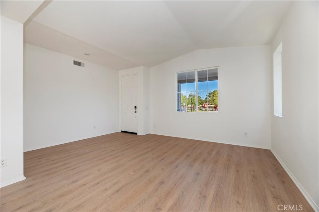 3215 Tumbleweed Road Hemet, CA 92545 - Photo 10 of 46 an empty room with wooden floor and windows