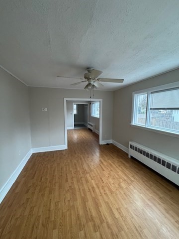 52 Curve Street, Unit 52 Dedham, MA 02026 - Photo 1 of 11 wooden floor in an empty room with a window