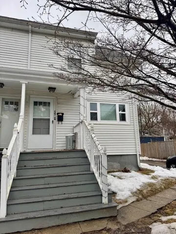 a view of a house with wooden fence